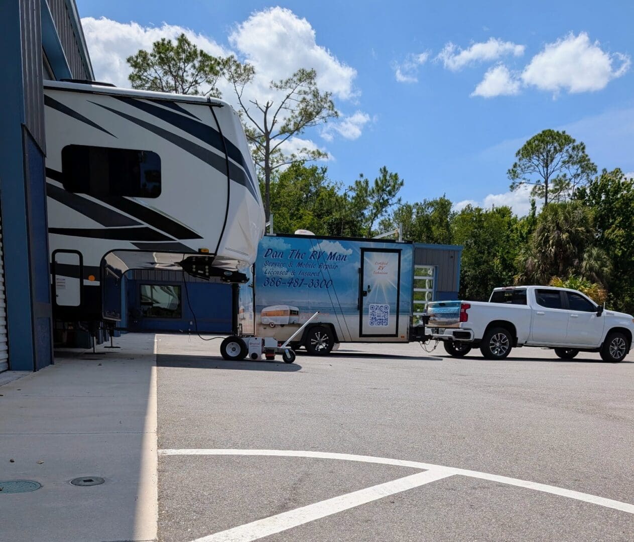 Pickup truck towing RV trailer in parking lot